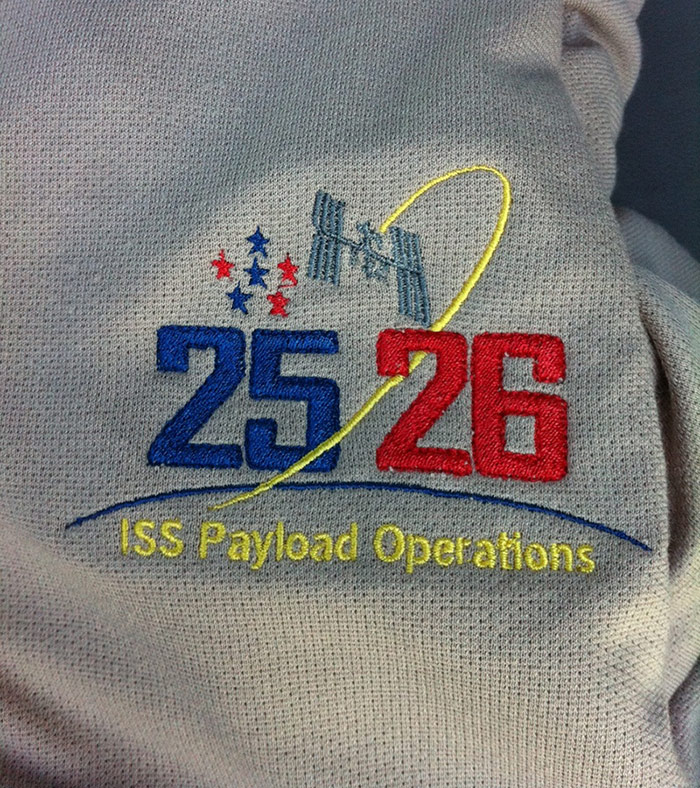 ISS Increment 25/26 Payload Operations Integration Center's mission shirt.